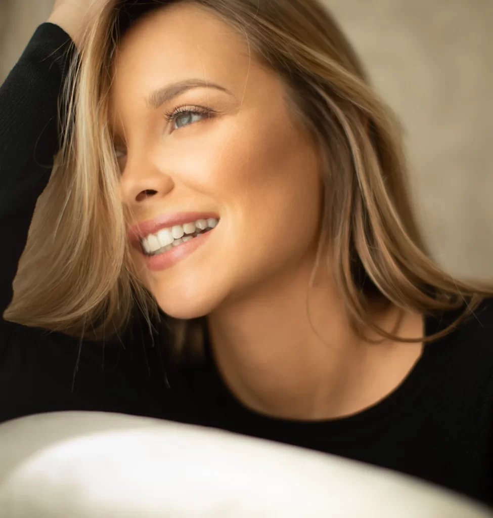 Smiling woman with even, clear skin tone