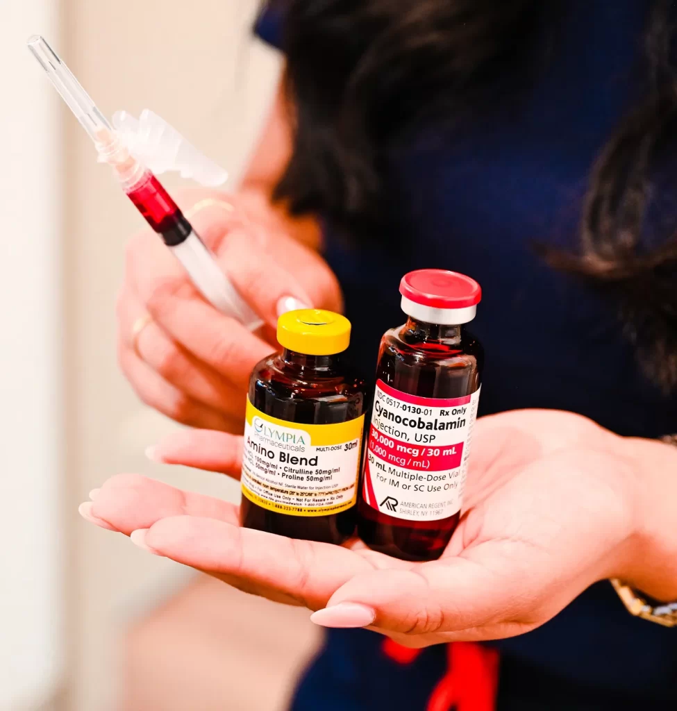Wellness injection vials and syringe held by a provider