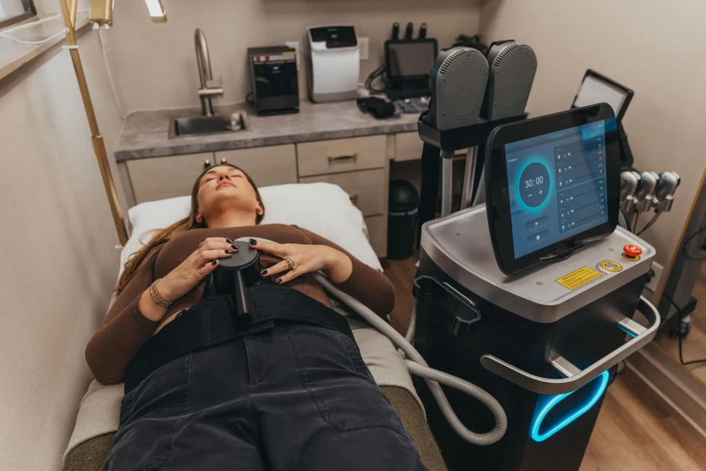 Client relaxing during a GeniSculpt muscle-building treatment