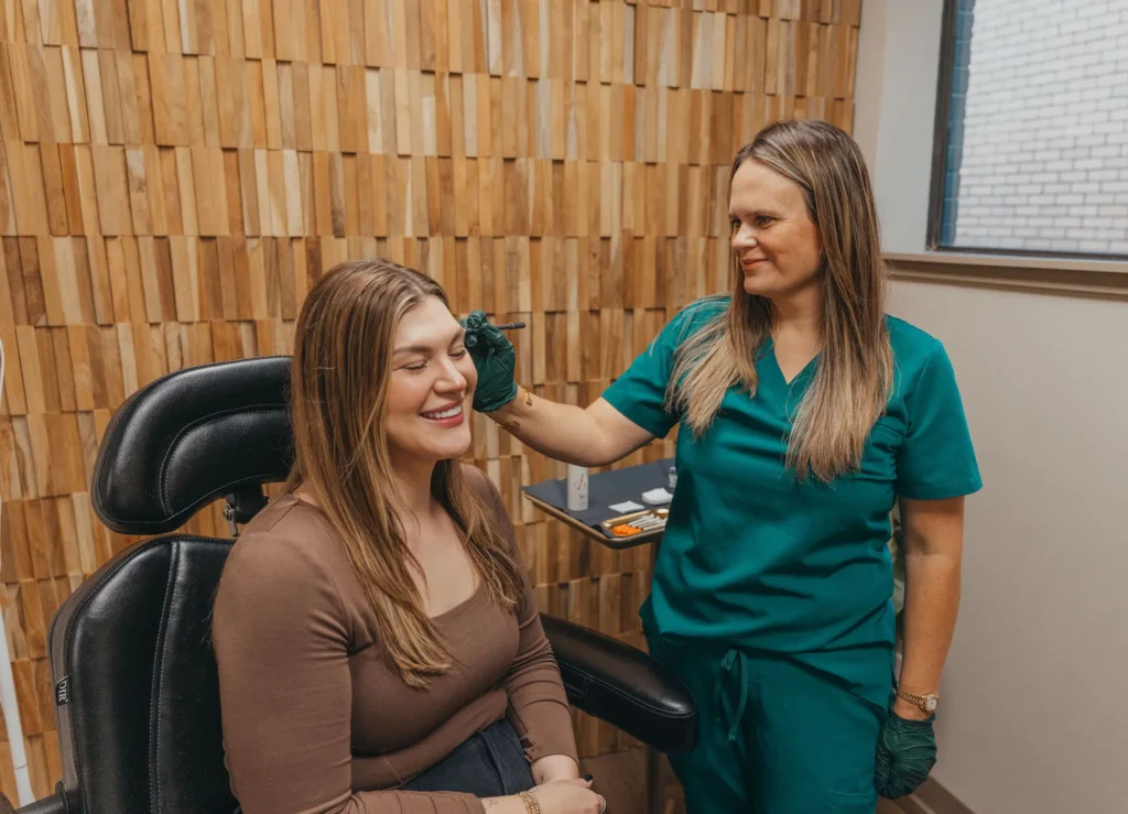 Provider consulting with a smiling client in a treatment chair