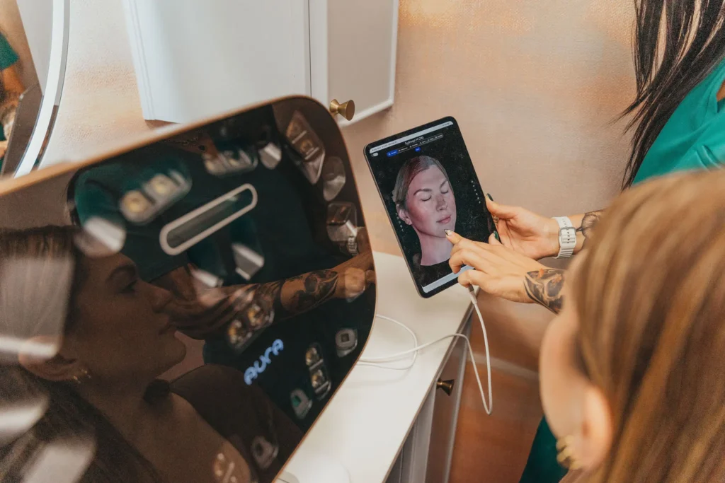 Provider reviewing an Aura skin analysis scan on a tablet