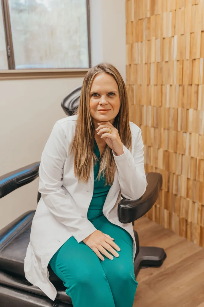 Provider in a white coat seated in a treatment room