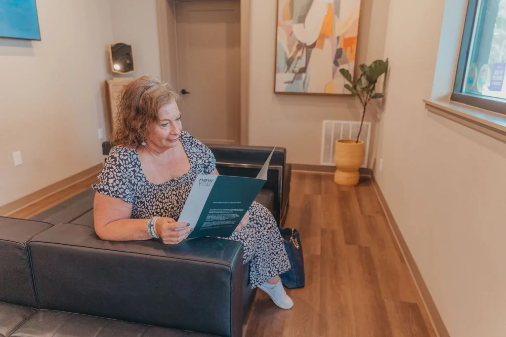 Client reading a brochure in the waiting area